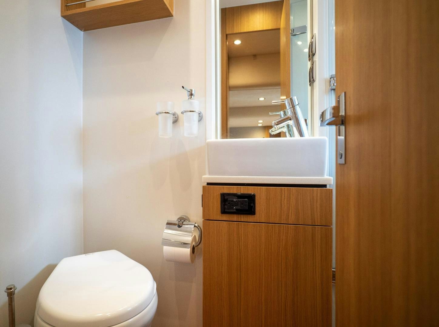 a bathroom with a toilet and sink aboard OCHO UNO Yacht for Sale