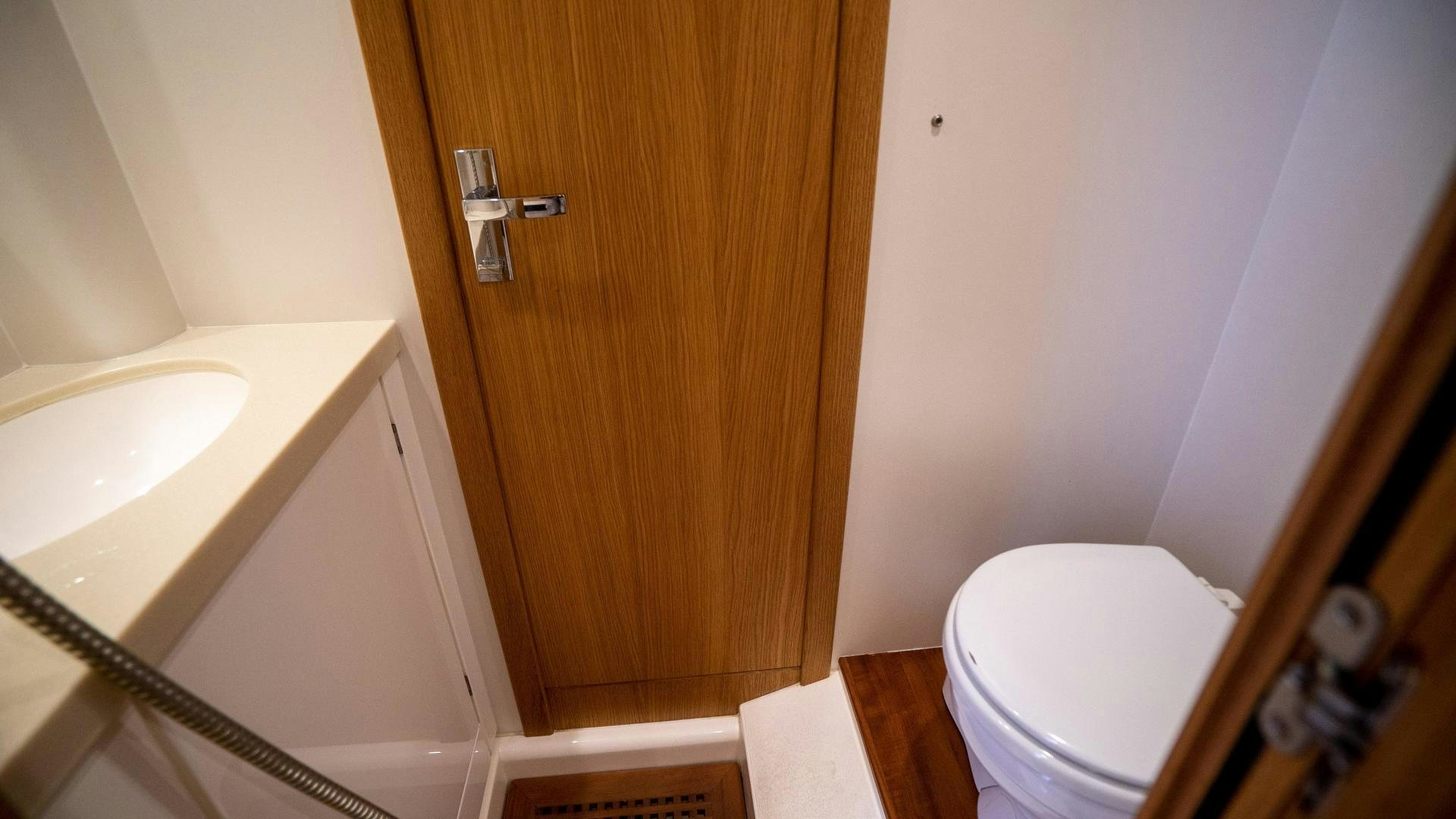 a bathroom with a toilet and a sink aboard OCHO UNO Yacht for Sale