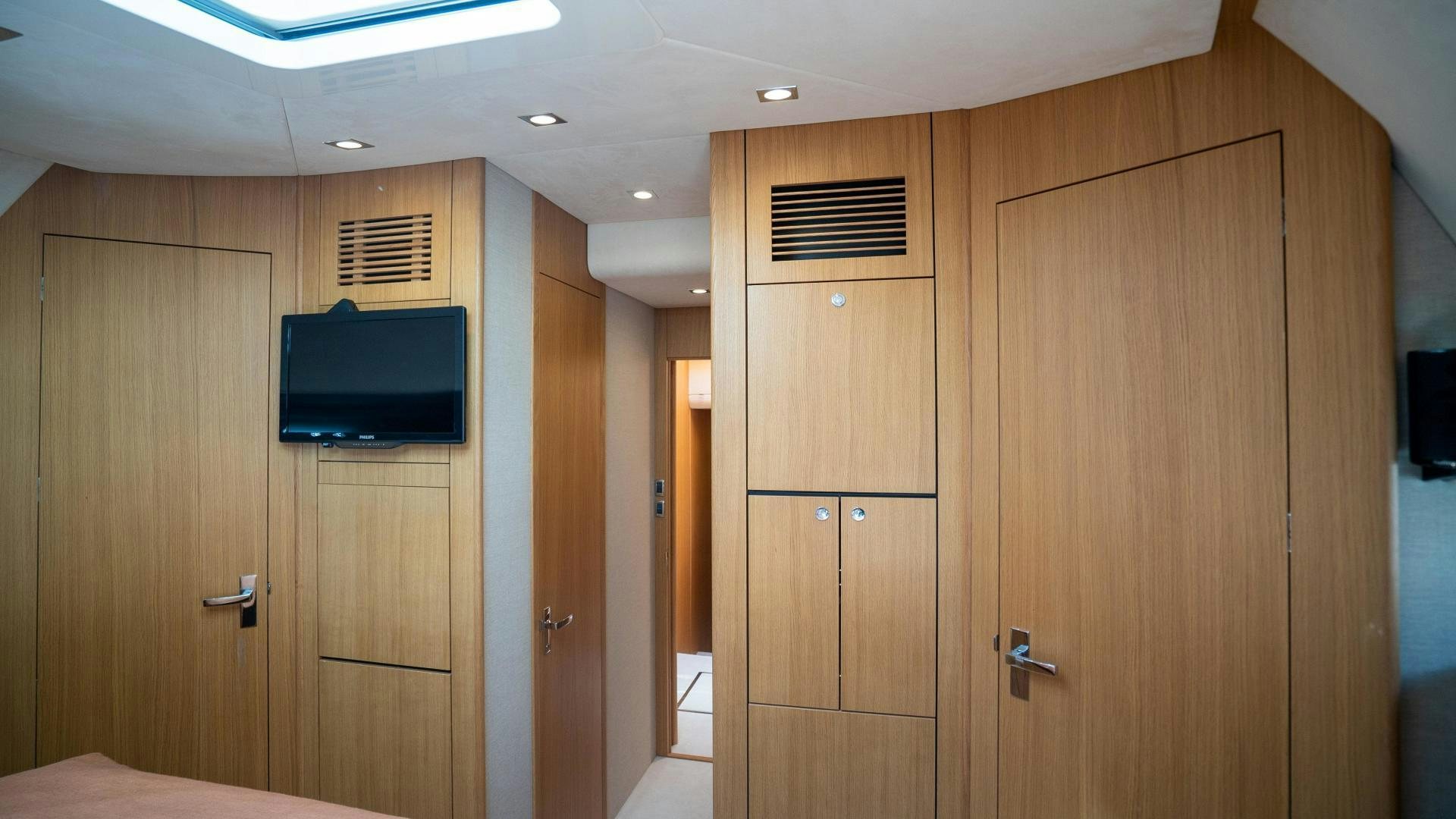 a room with wooden cabinets aboard OCHO UNO Yacht for Sale