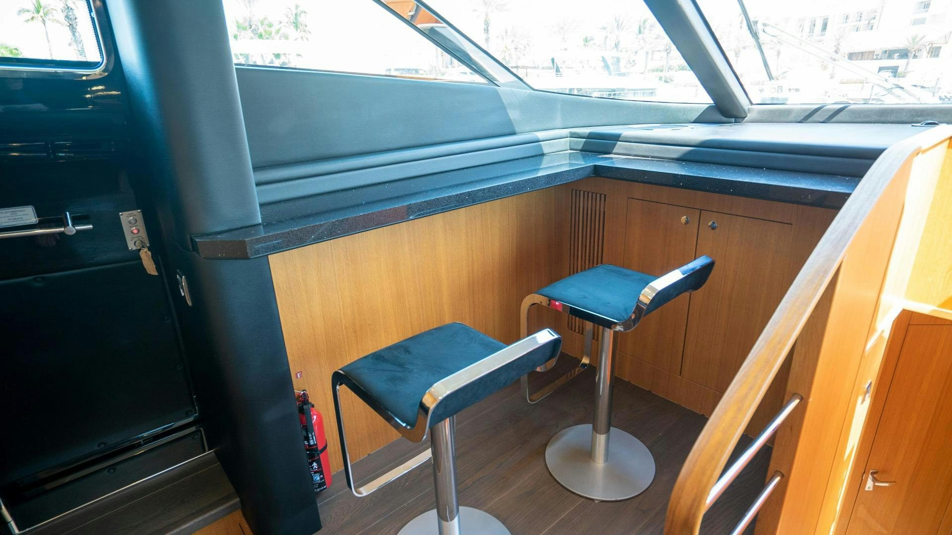 a blue chair in a room aboard OCHO UNO Yacht for Sale