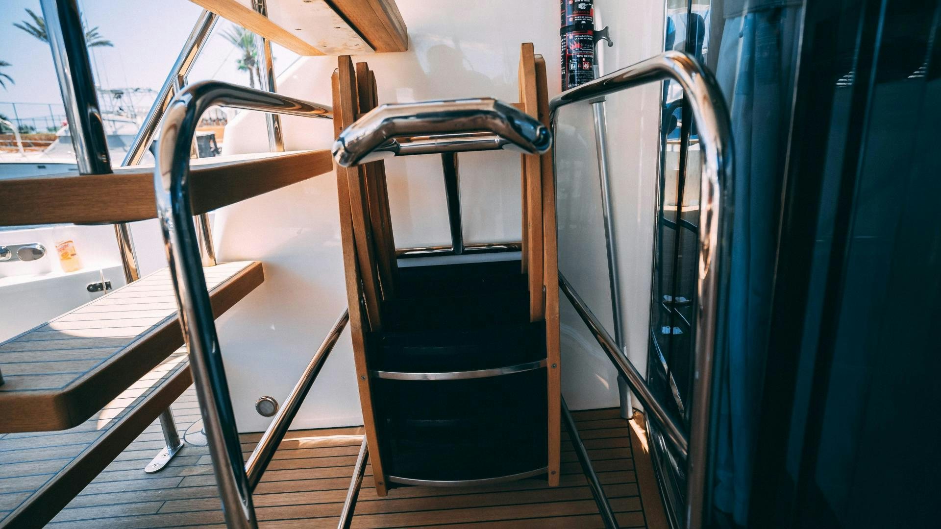 a black chair on a wooden deck aboard OCHO UNO Yacht for Sale