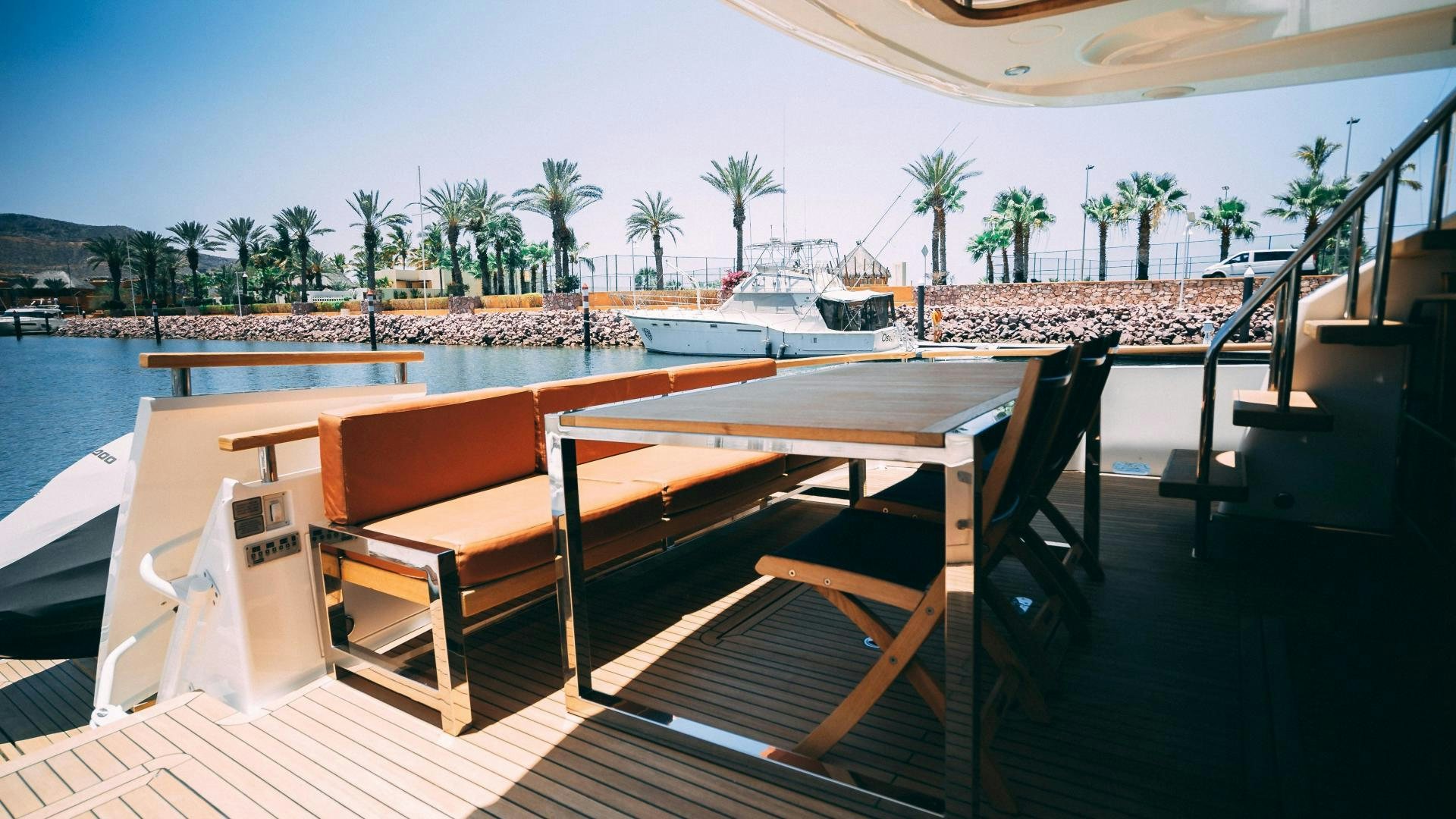 a deck with chairs and tables aboard OCHO UNO Yacht for Sale