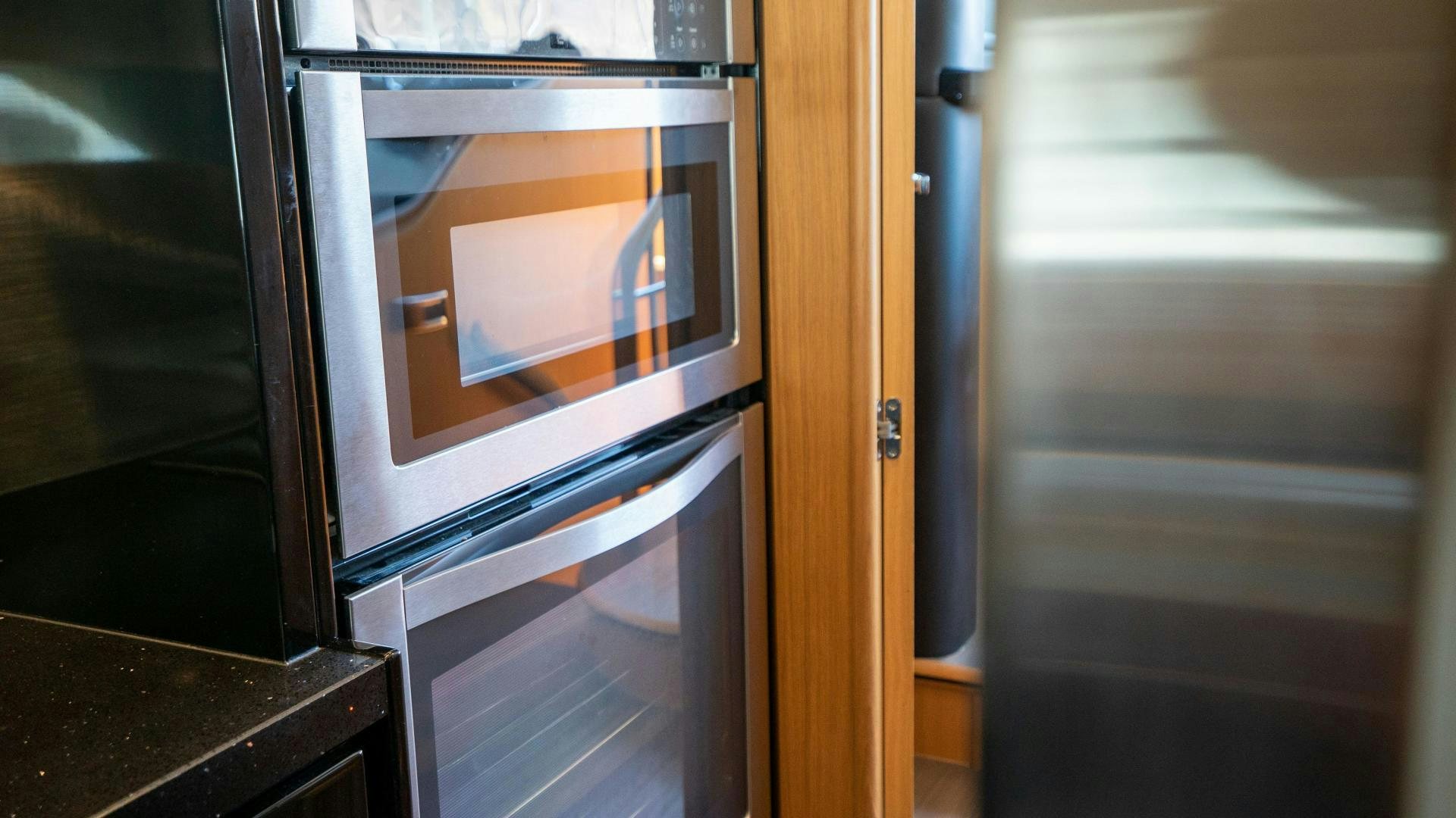a kitchen with a microwave oven aboard OCHO UNO Yacht for Sale