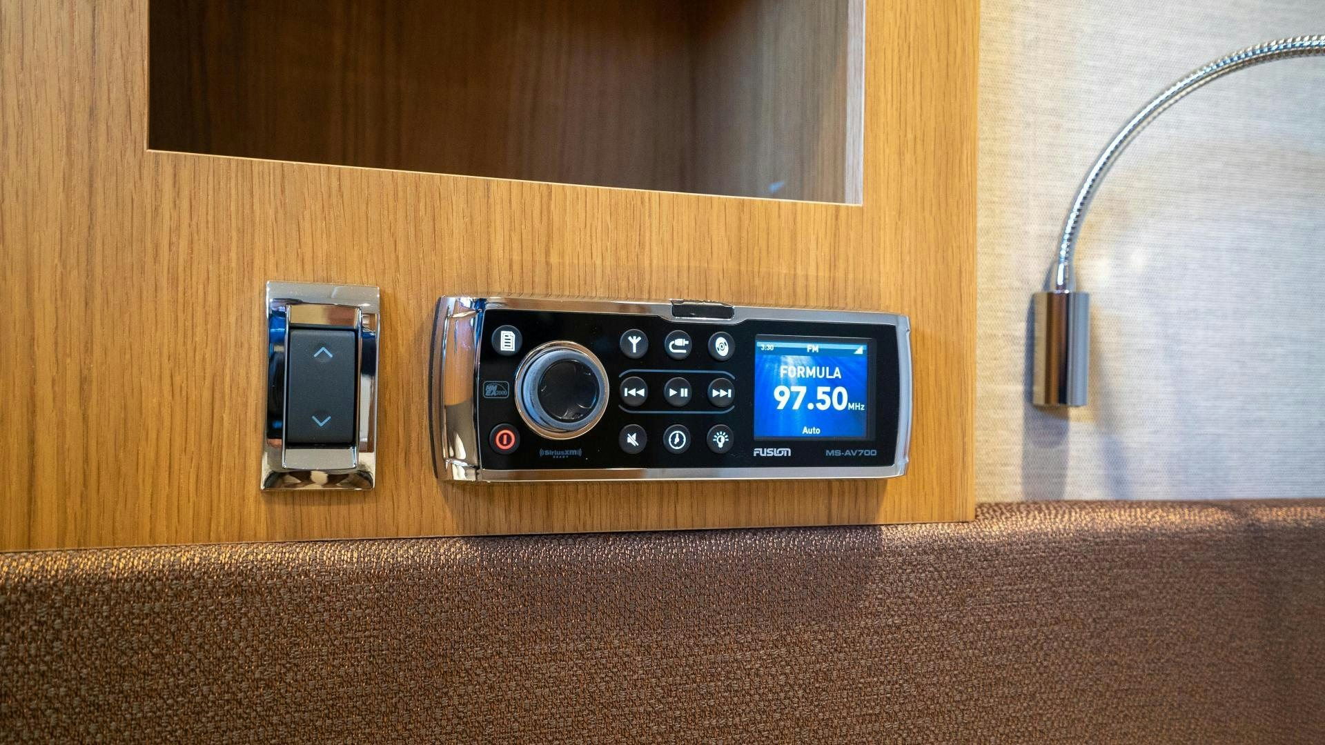 a black electronic device on a wood surface aboard OCHO UNO Yacht for Sale