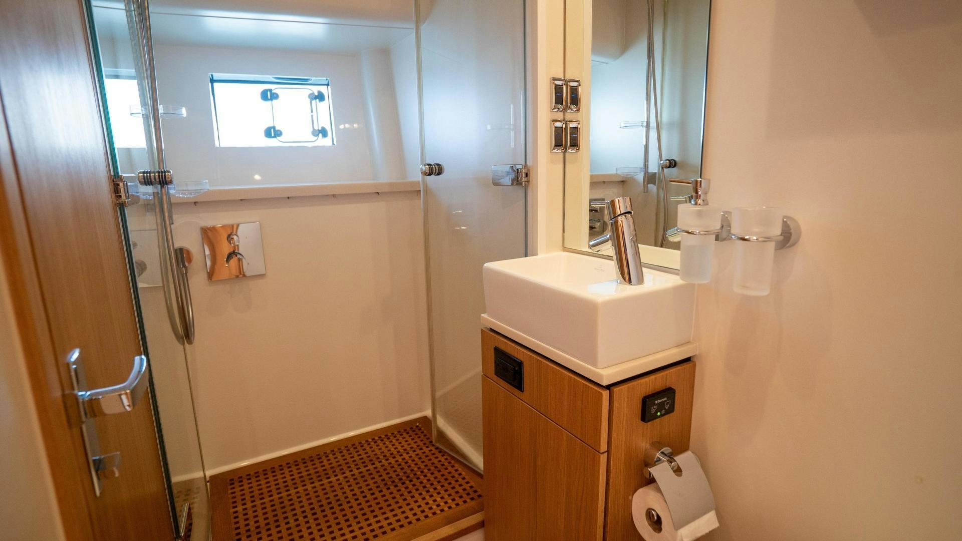 a bathroom with a sink and a mirror aboard OCHO UNO Yacht for Sale