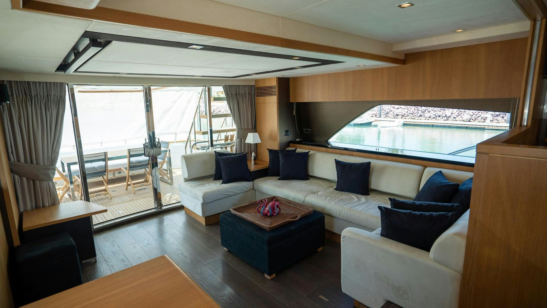 a living room with a large balcony aboard OCHO UNO Yacht for Sale