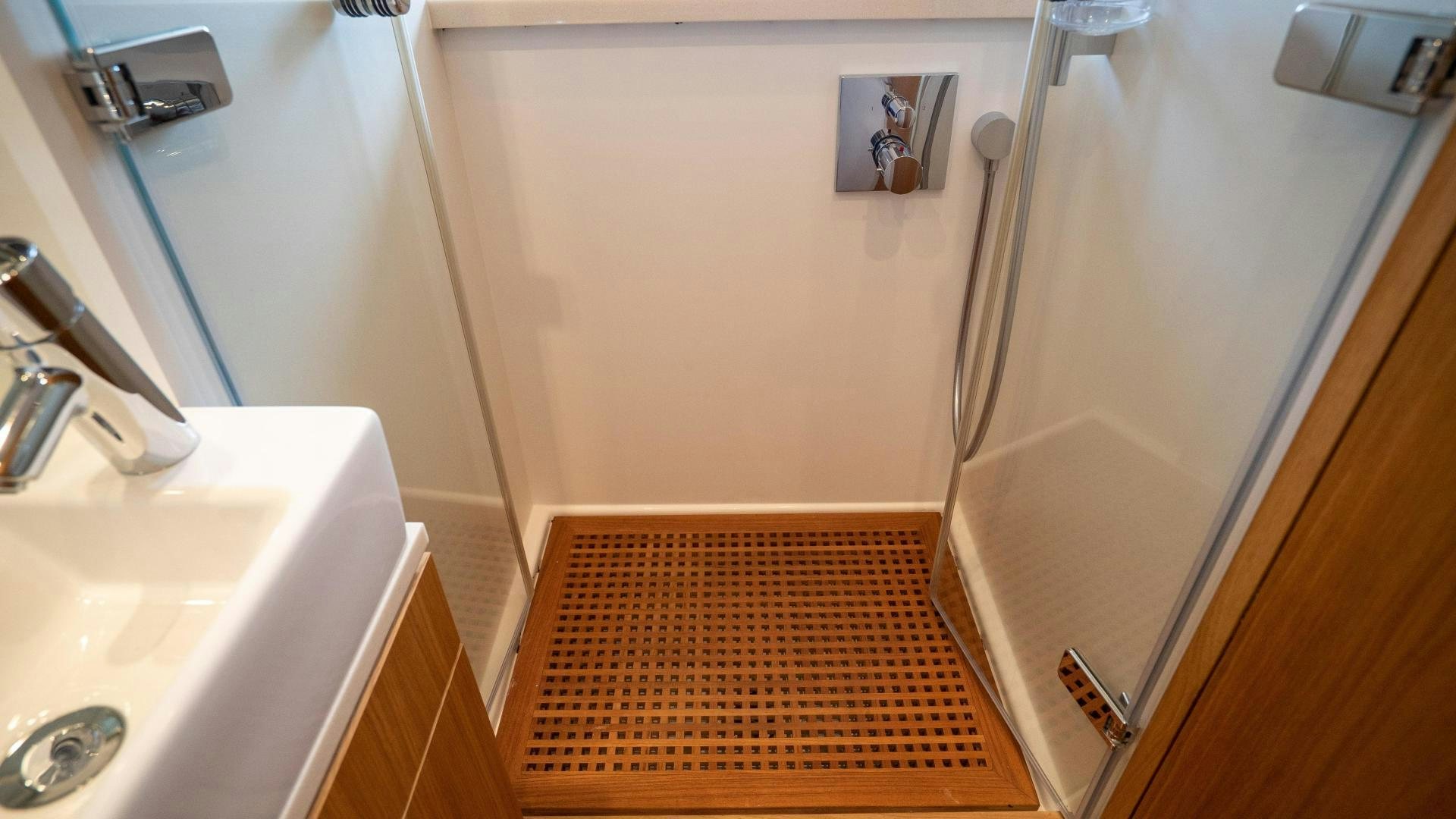 a bathroom with a shower and sink aboard OCHO UNO Yacht for Sale