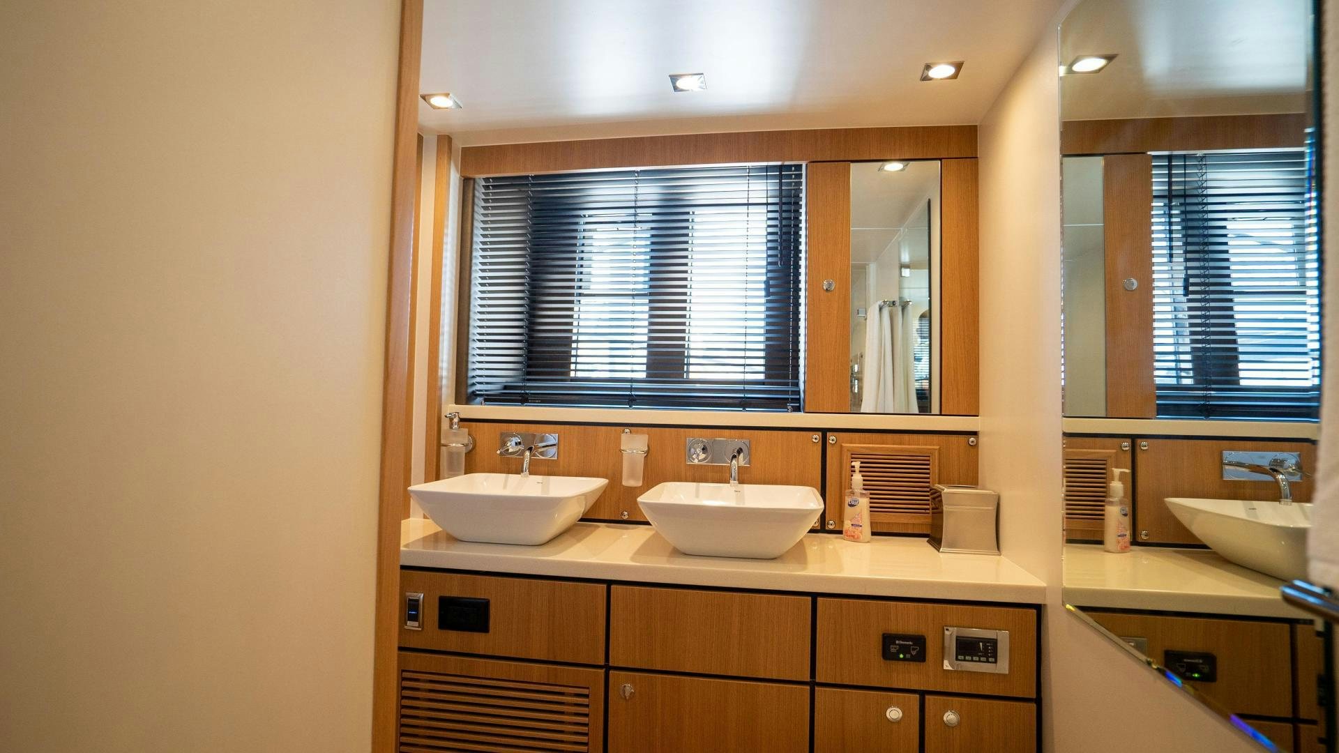 a bathroom with two sinks aboard OCHO UNO Yacht for Sale