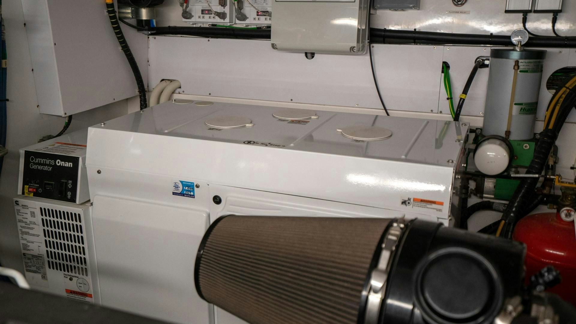 a white machine with a black object on the side aboard OCHO UNO Yacht for Sale