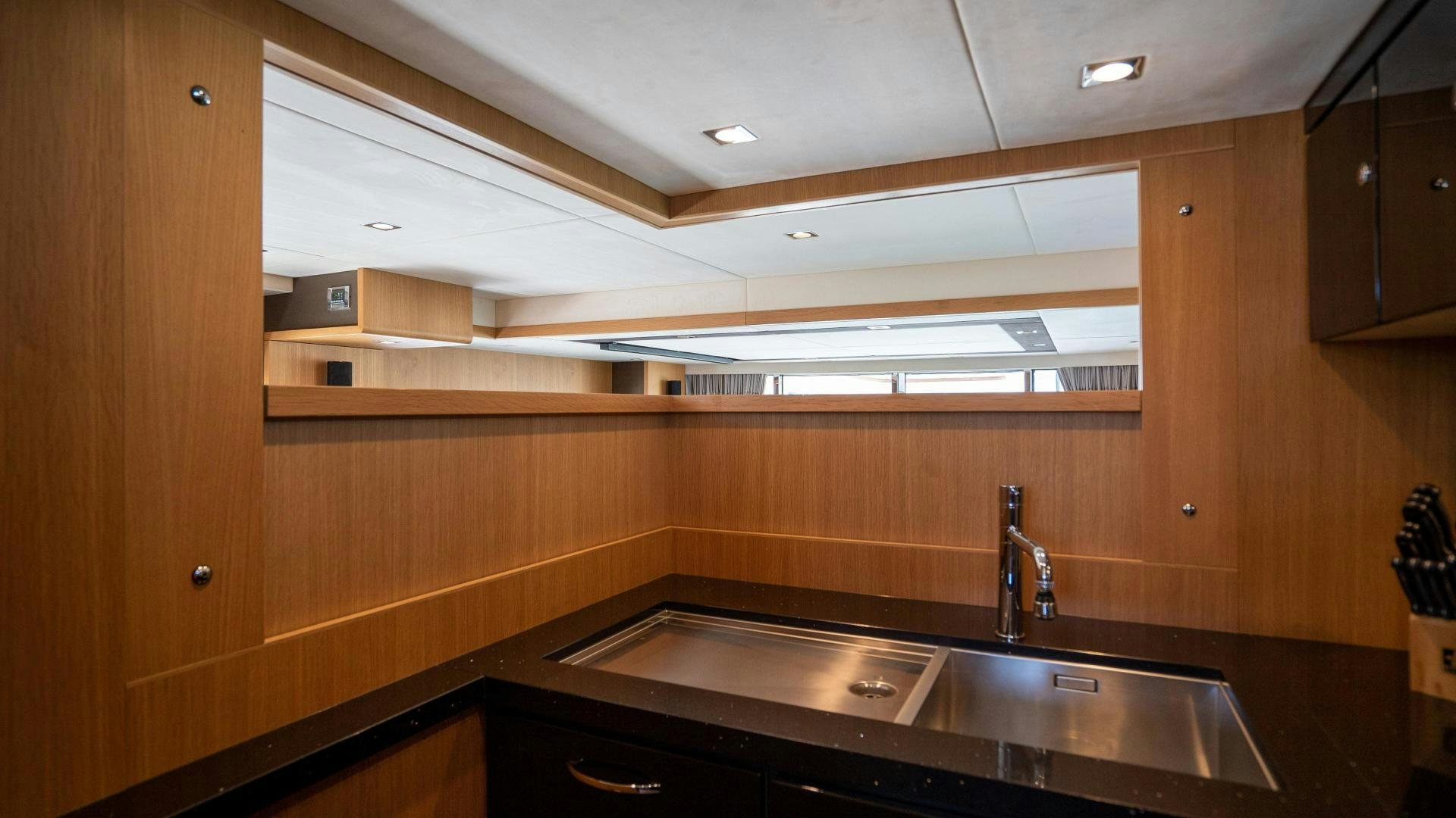 a kitchen with a large island aboard OCHO UNO Yacht for Sale