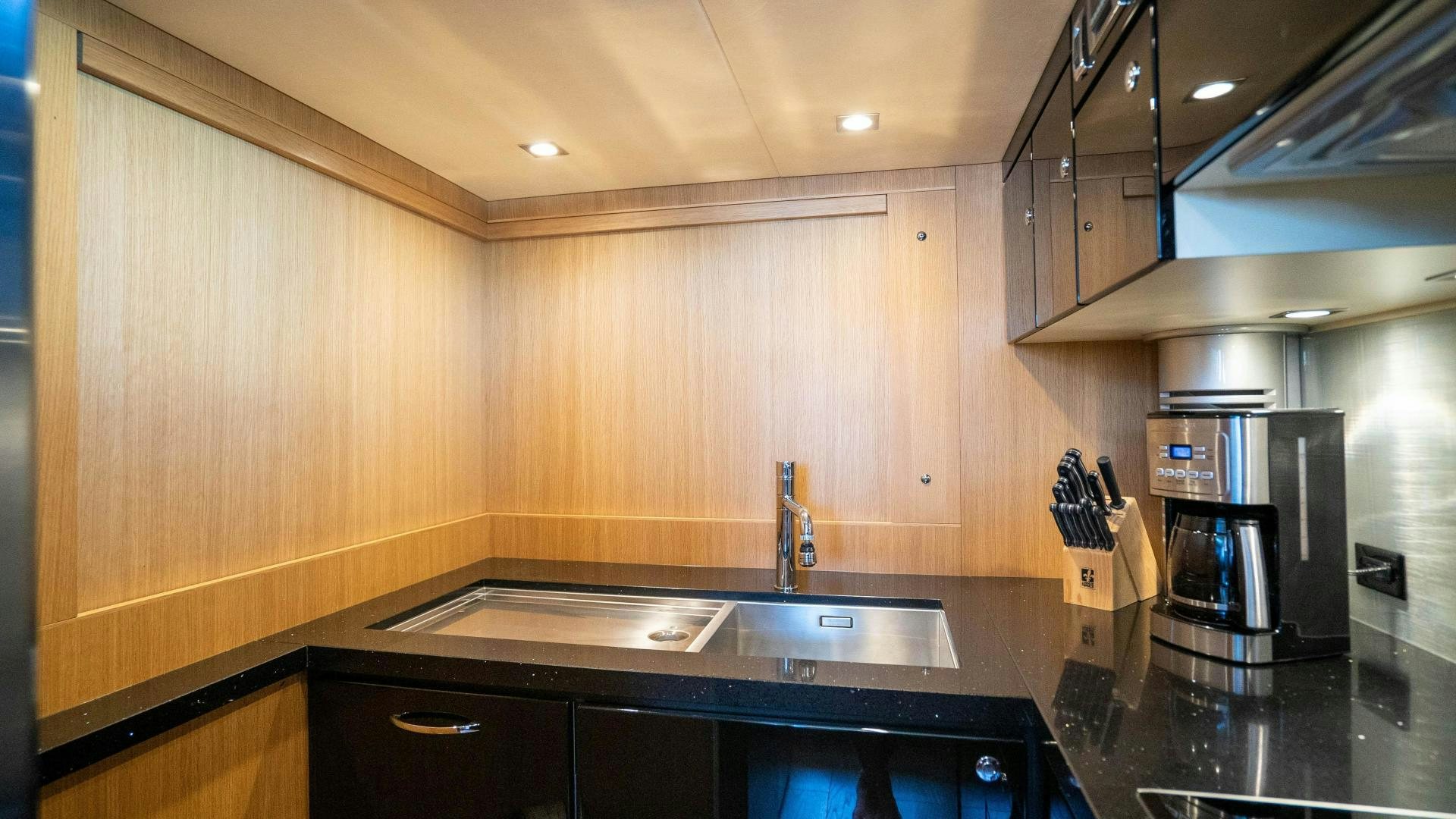 a kitchen with a stainless steel sink aboard OCHO UNO Yacht for Sale