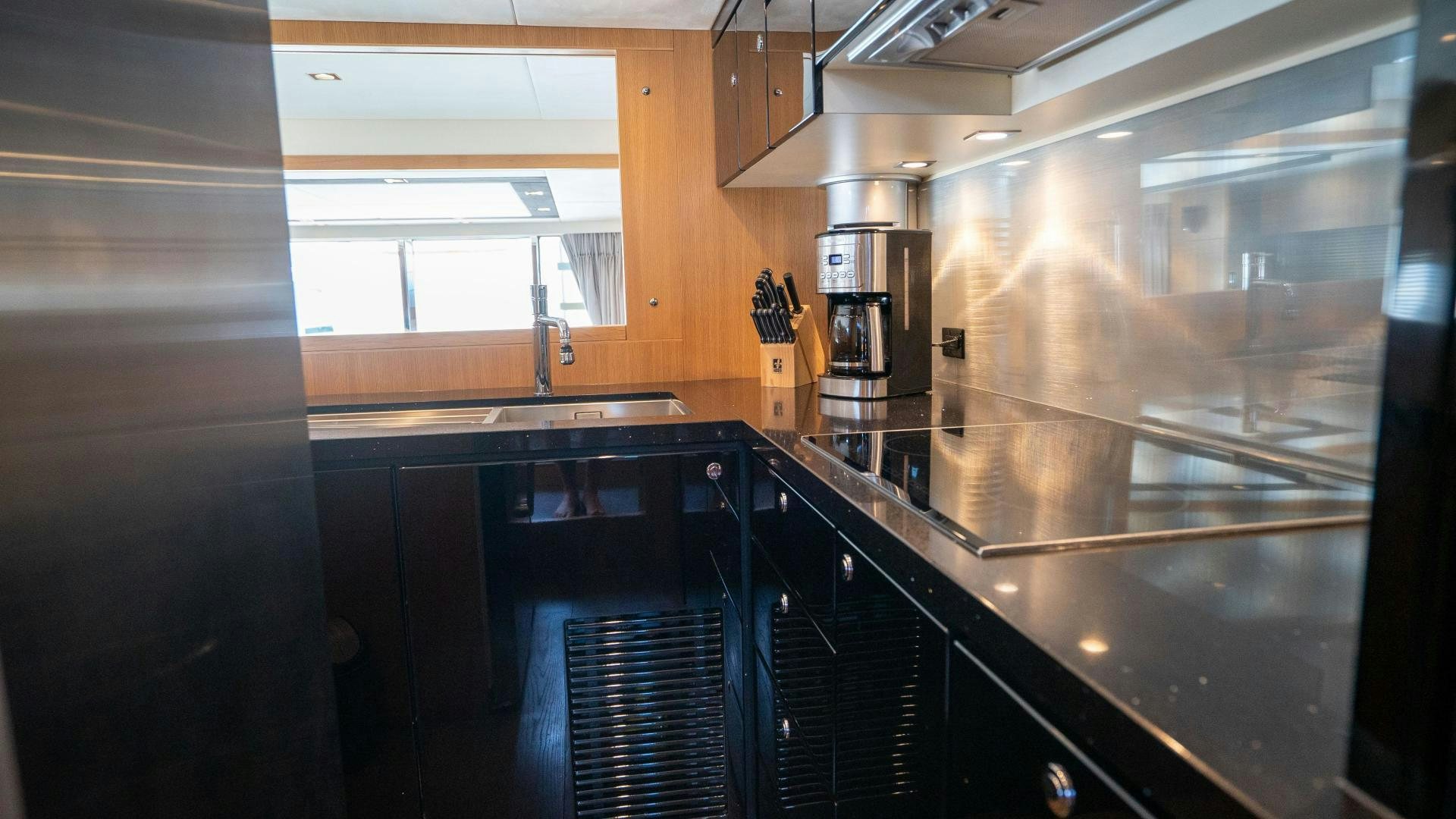 a kitchen with a glass door aboard OCHO UNO Yacht for Sale