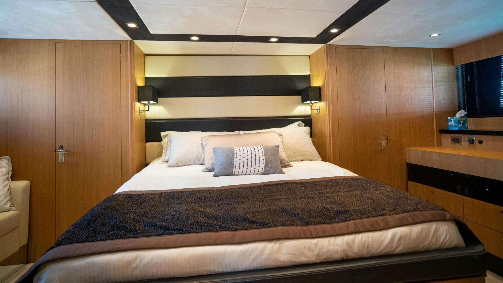 a bed with a brown bed spread aboard OCHO UNO Yacht for Sale
