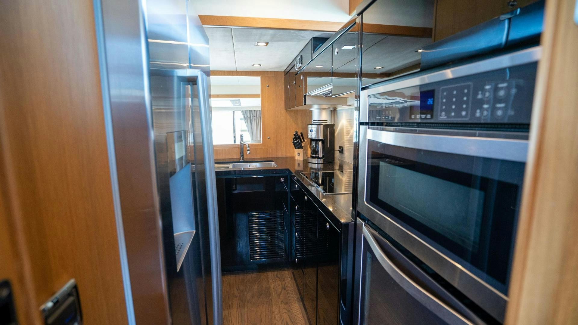 a kitchen with stainless steel appliances aboard OCHO UNO Yacht for Sale