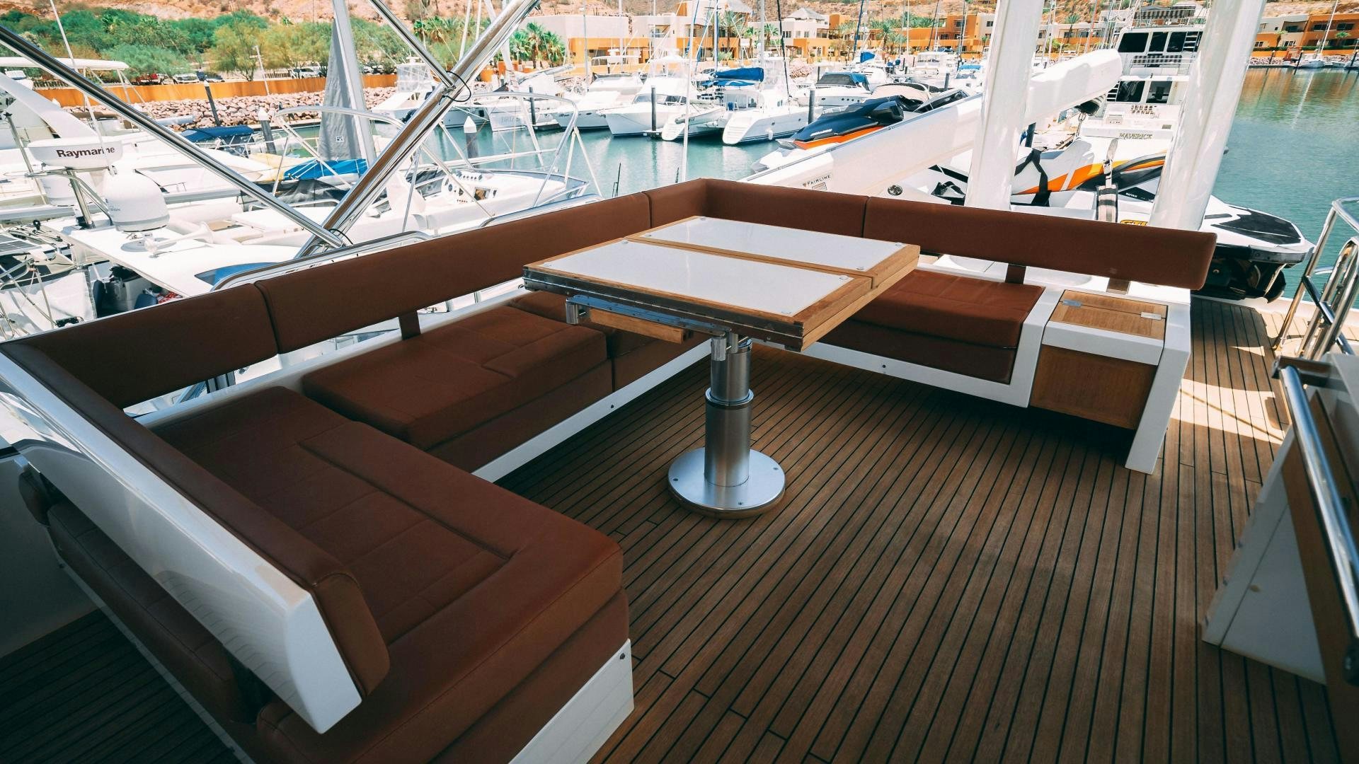 a deck with a table and chairs aboard OCHO UNO Yacht for Sale
