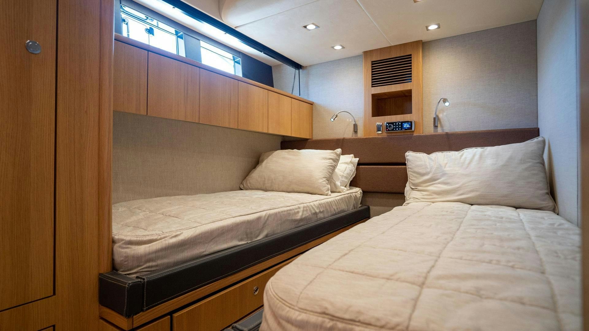 a room with two beds aboard OCHO UNO Yacht for Sale
