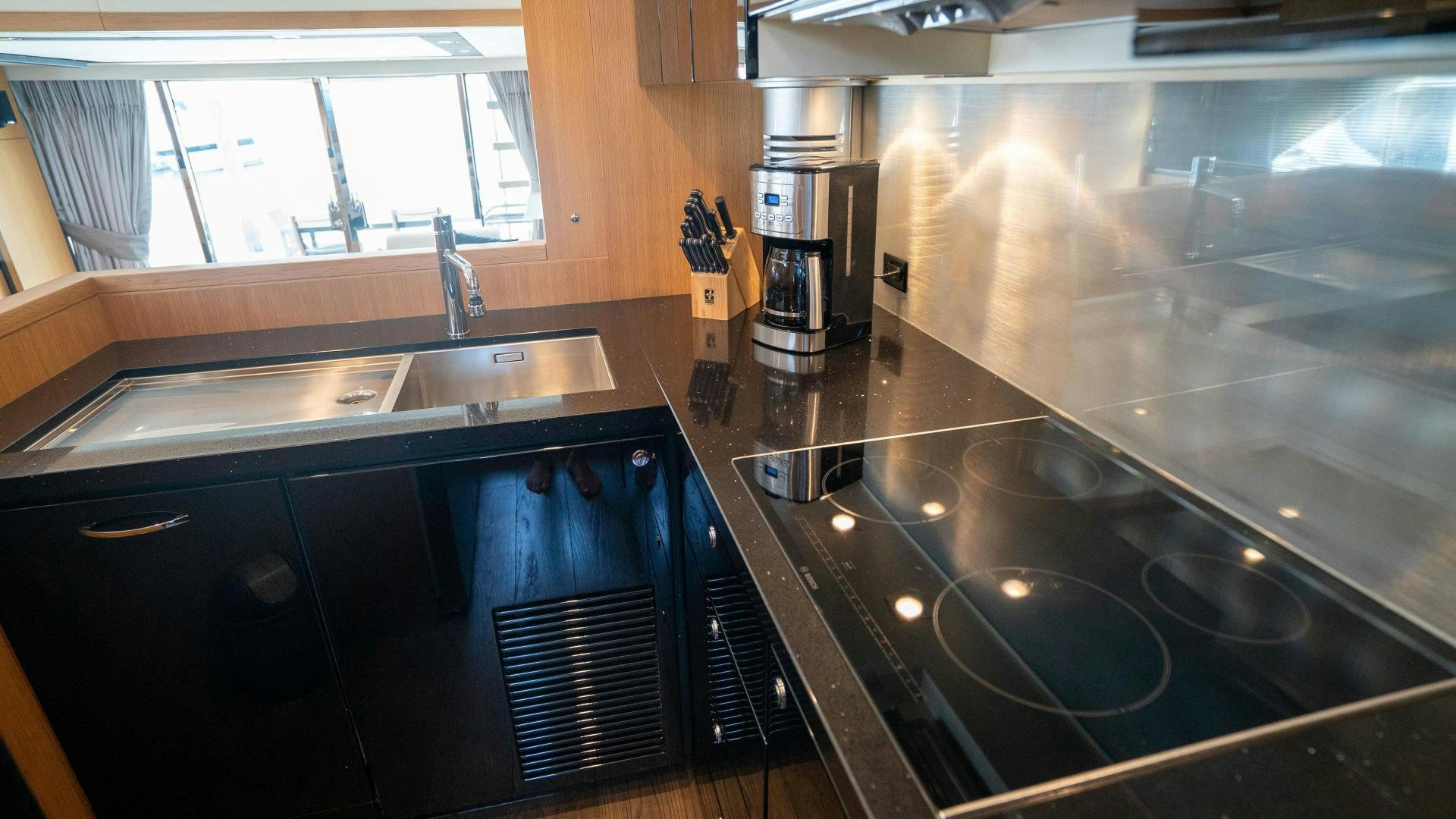 a kitchen with a stainless steel sink aboard OCHO UNO Yacht for Sale