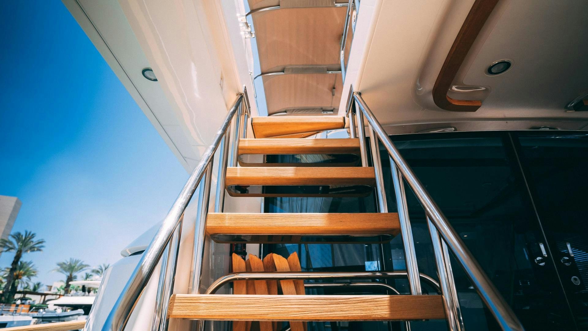 a white boat with wooden seats aboard OCHO UNO Yacht for Sale