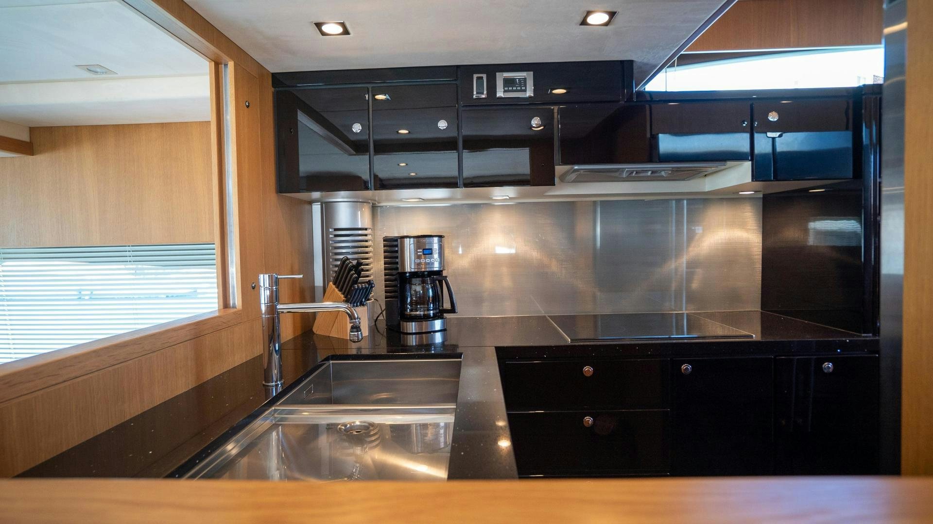 a kitchen with a sink and a microwave aboard OCHO UNO Yacht for Sale