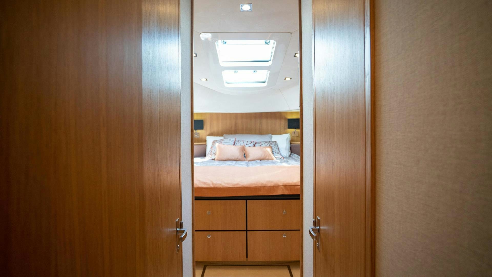 a room with a bed and a closet aboard OCHO UNO Yacht for Sale