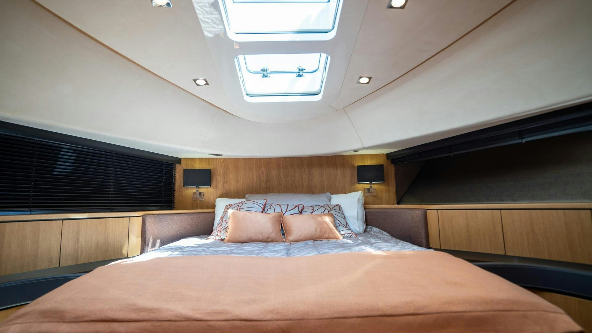 a bed with a brown comforter aboard OCHO UNO Yacht for Sale