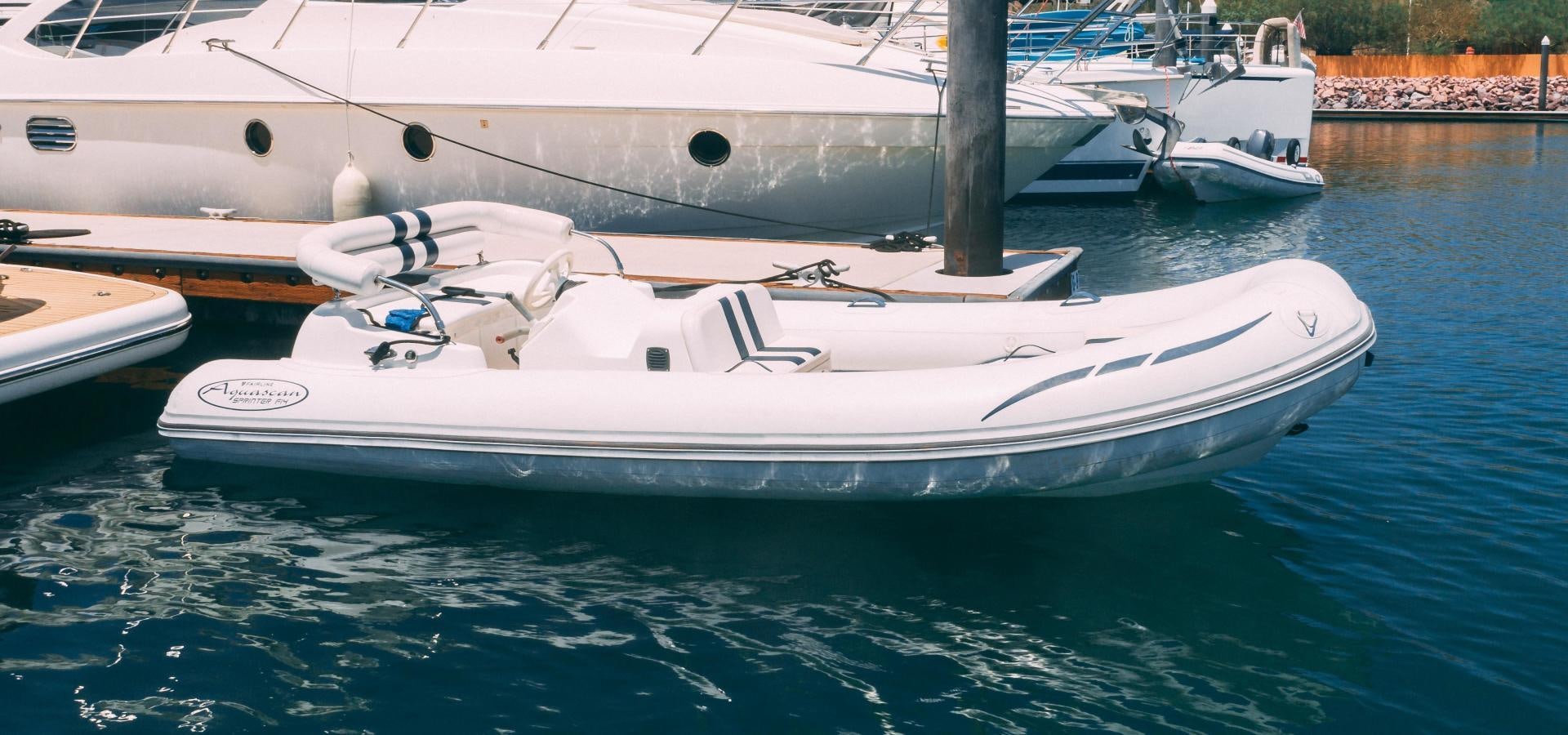 a couple of boats in a harbor aboard OCHO UNO Yacht for Sale
