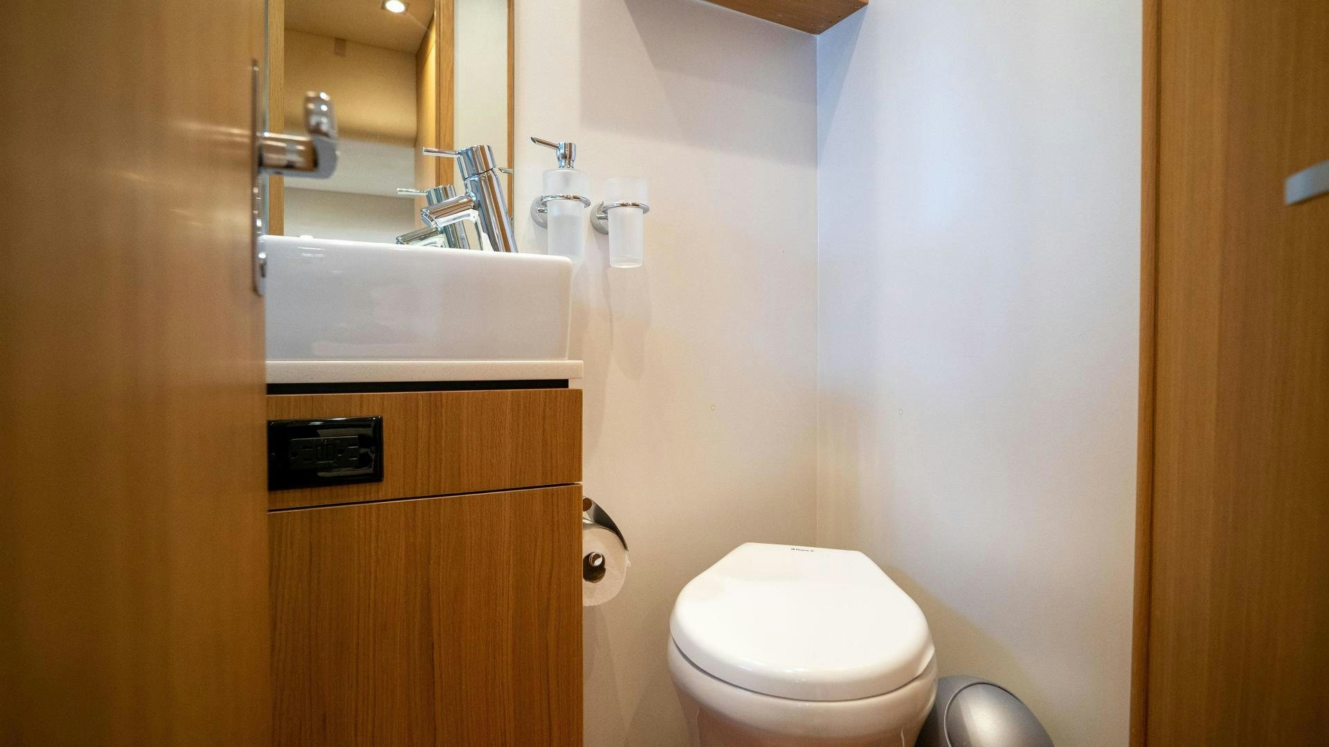 a bathroom with a sink and toilet aboard OCHO UNO Yacht for Sale