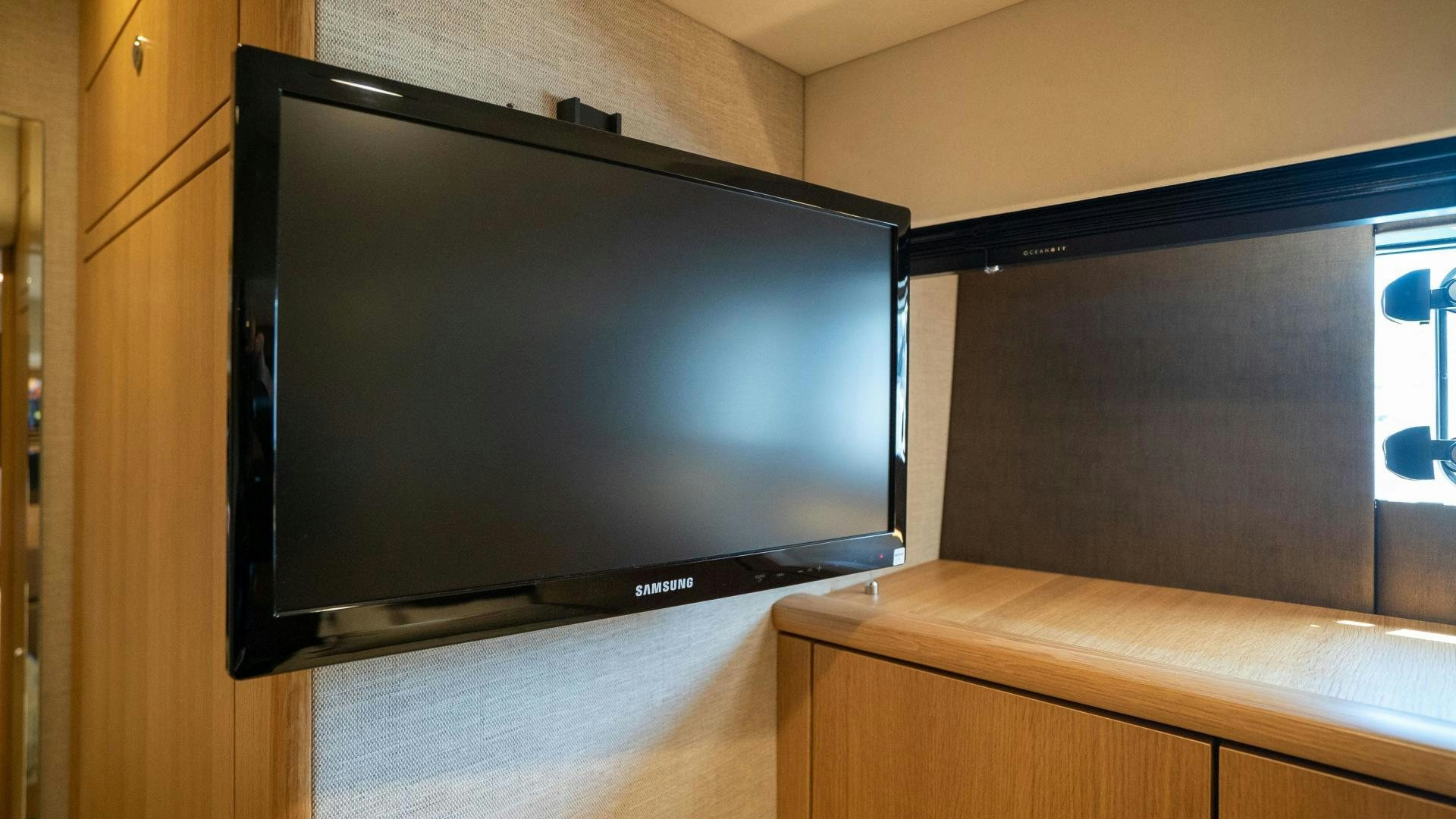 a tv on a cabinet aboard OCHO UNO Yacht for Sale