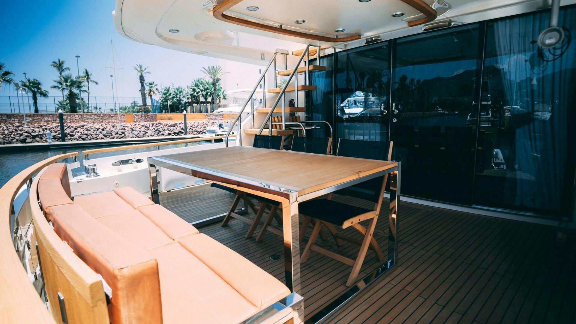 a table and chairs on a deck aboard OCHO UNO Yacht for Sale