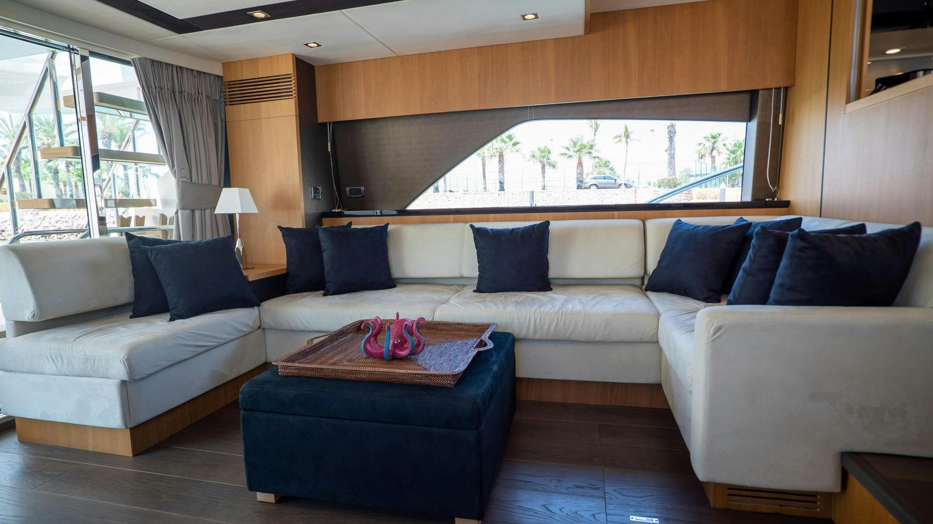 a large white couch with pillows aboard OCHO UNO Yacht for Sale