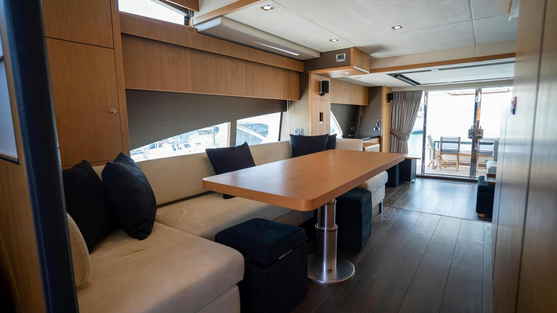 a room with a table and chairs aboard OCHO UNO Yacht for Sale