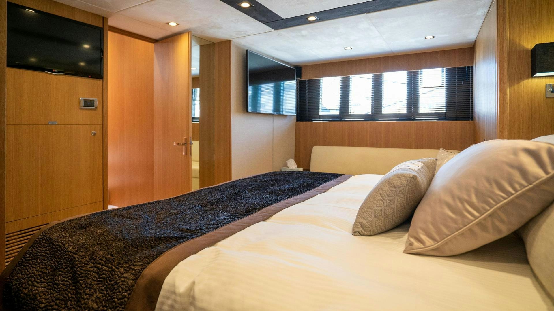 a bed with a white sheet aboard OCHO UNO Yacht for Sale