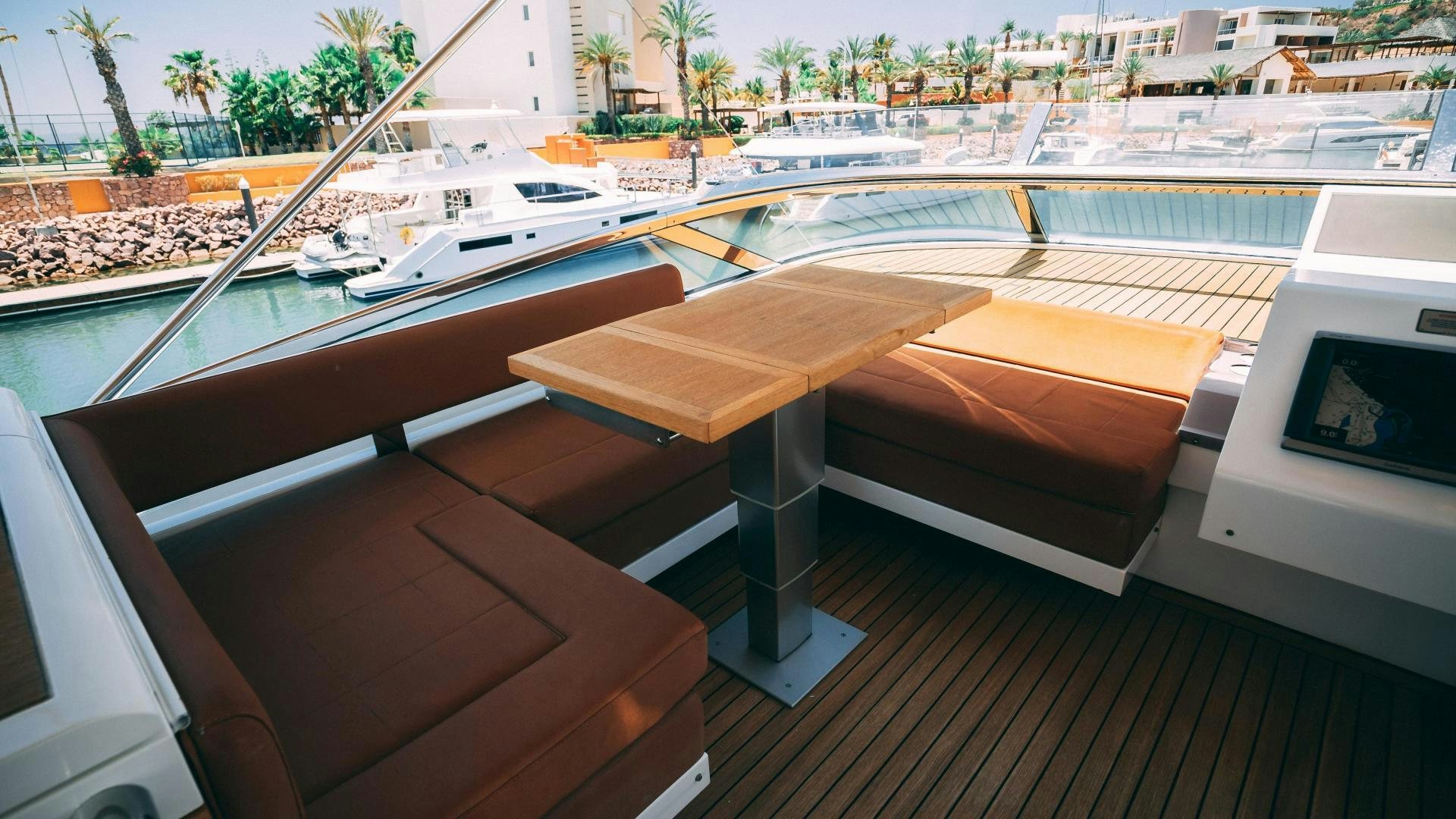a room with a table and chairs aboard OCHO UNO Yacht for Sale