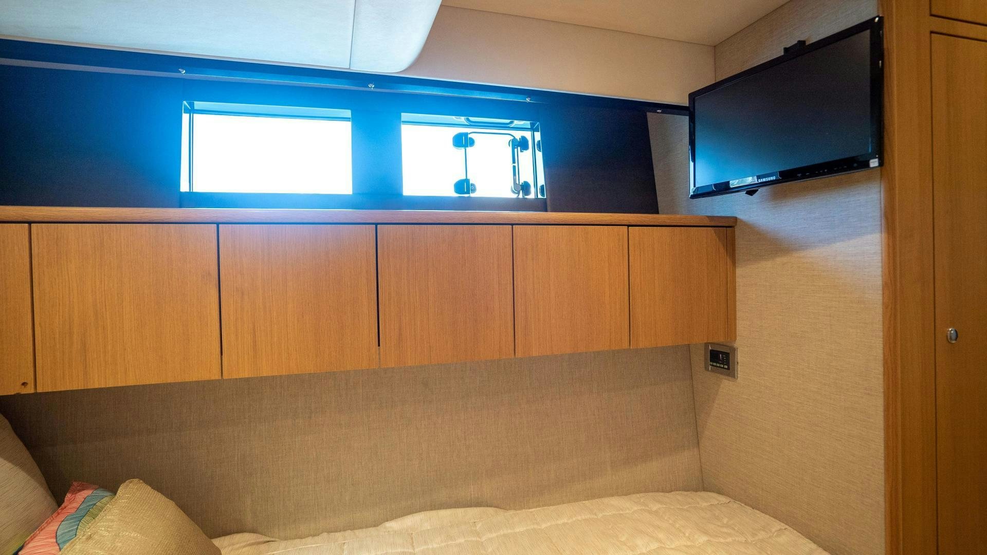 a room with a couch and tv aboard OCHO UNO Yacht for Sale