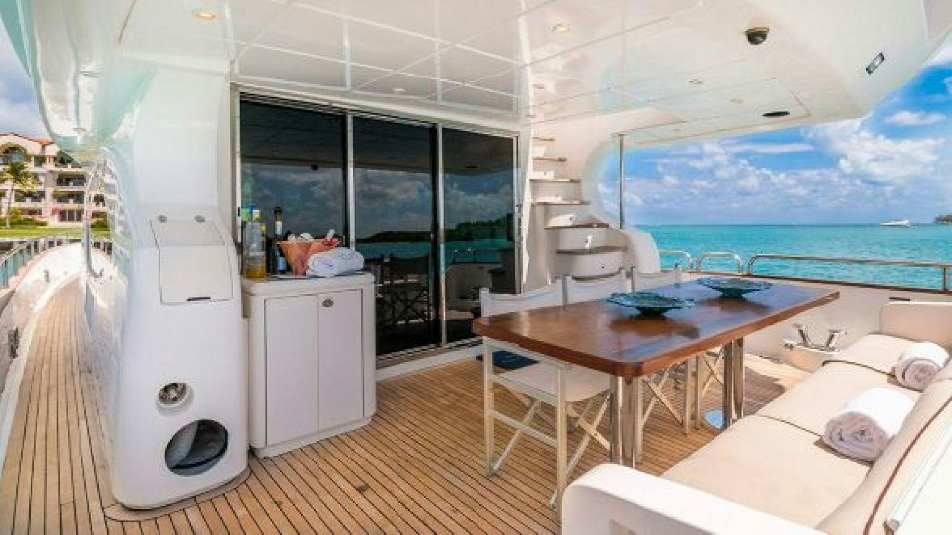 a room with a table and a bed aboard NO LIMITS Yacht for Sale