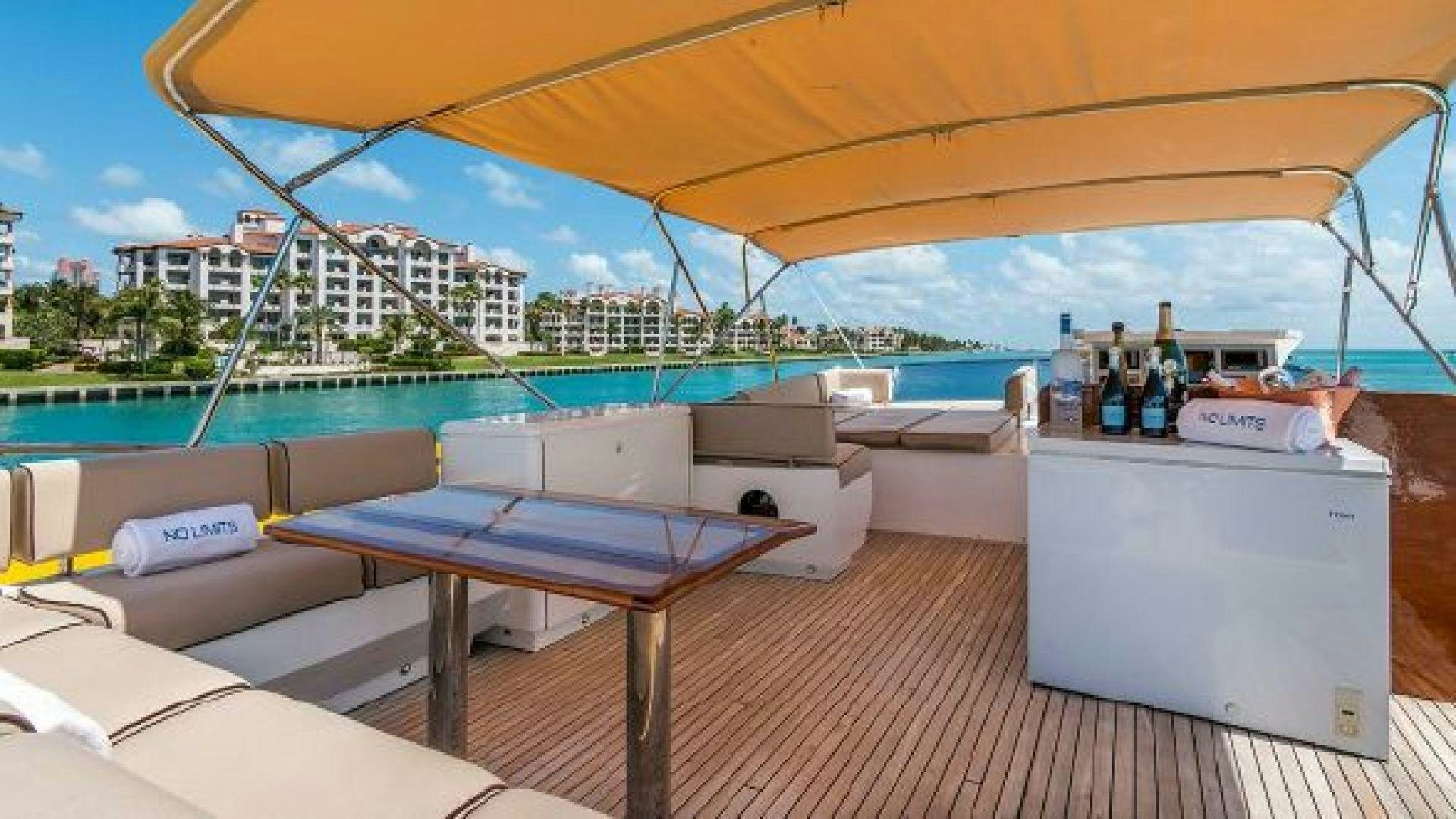 a table and chairs on a deck aboard NO LIMITS Yacht for Sale