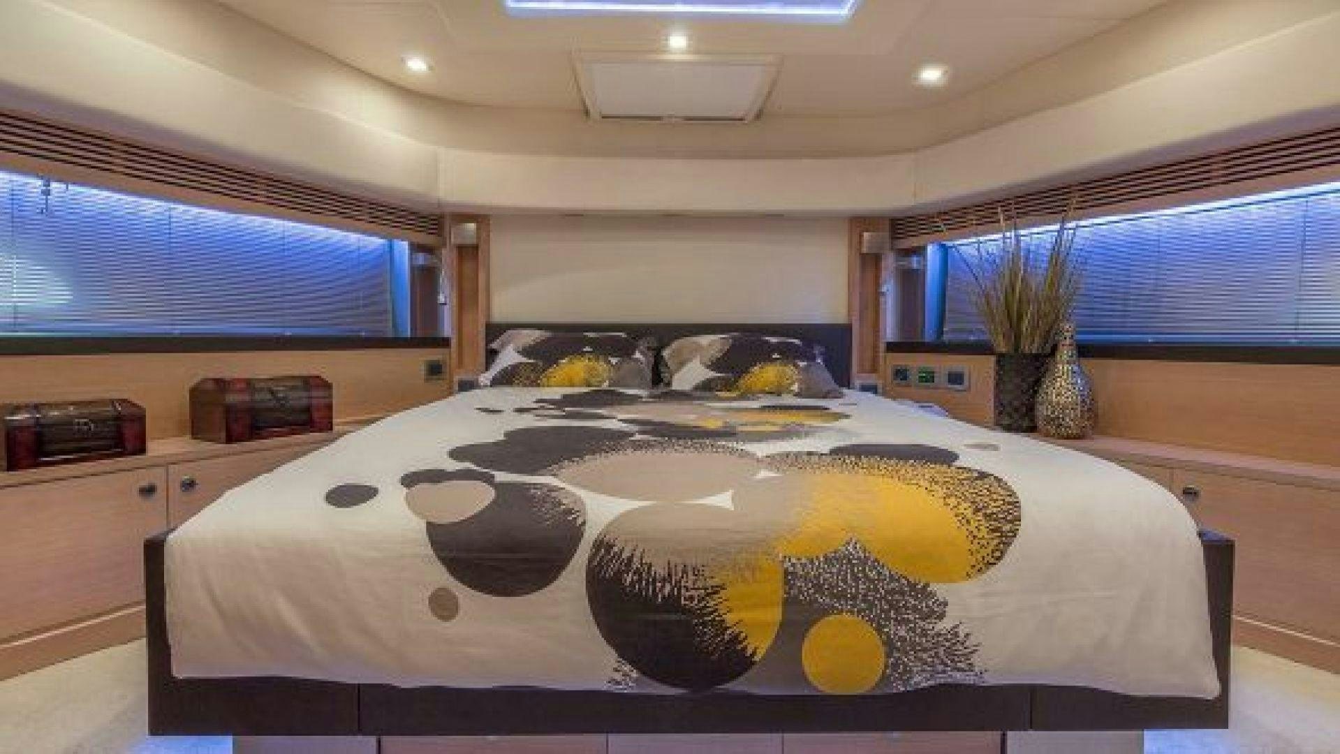 a large white bed with a painting on it aboard NO LIMITS Yacht for Sale