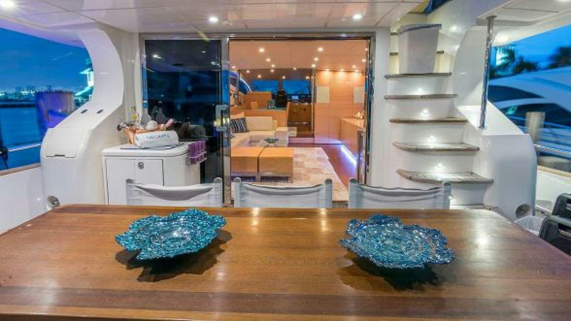 a large room with a table and a large display of blue and white stones aboard NO LIMITS Yacht for Sale