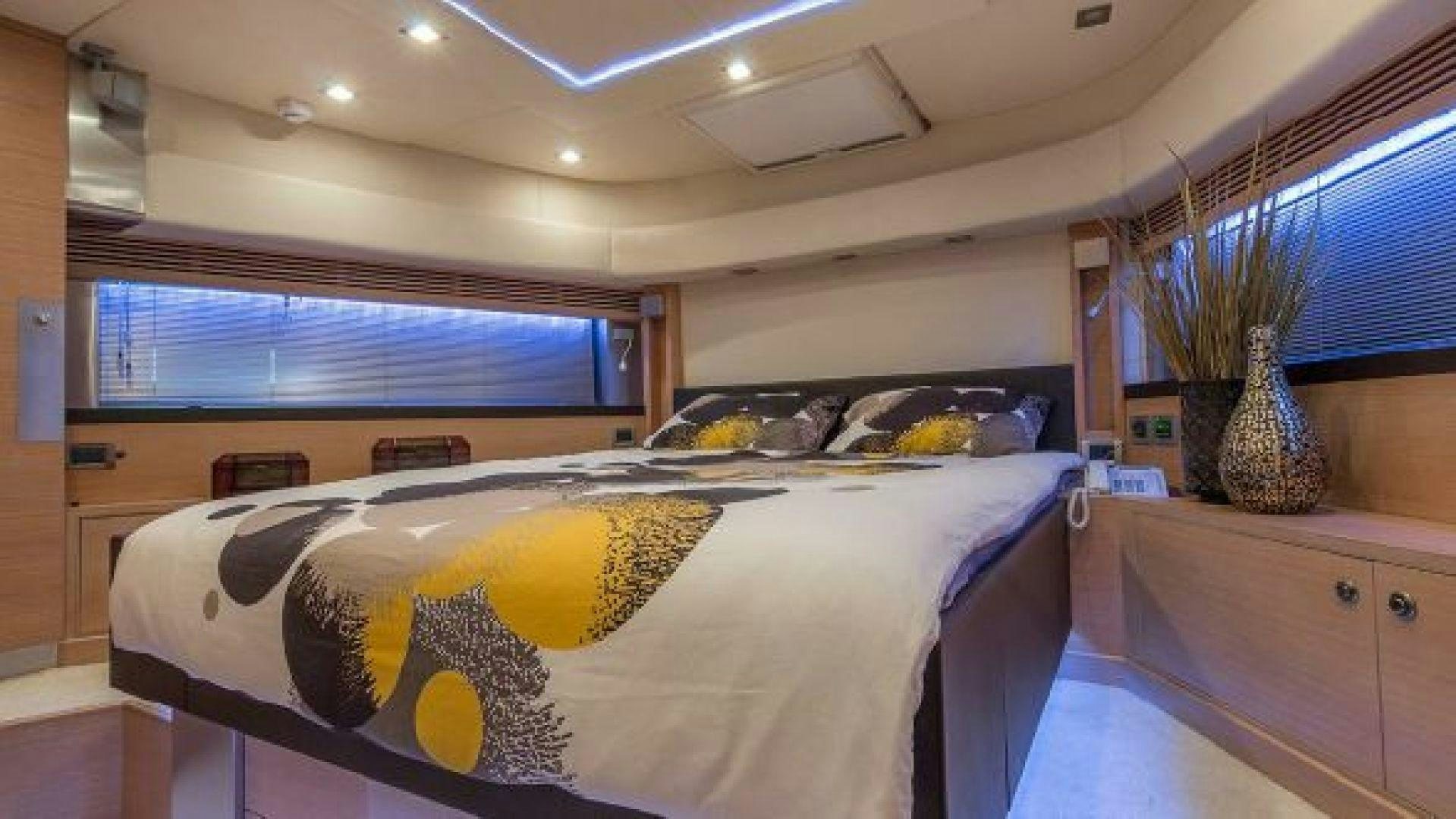 a bedroom with a bed and a desk aboard NO LIMITS Yacht for Sale
