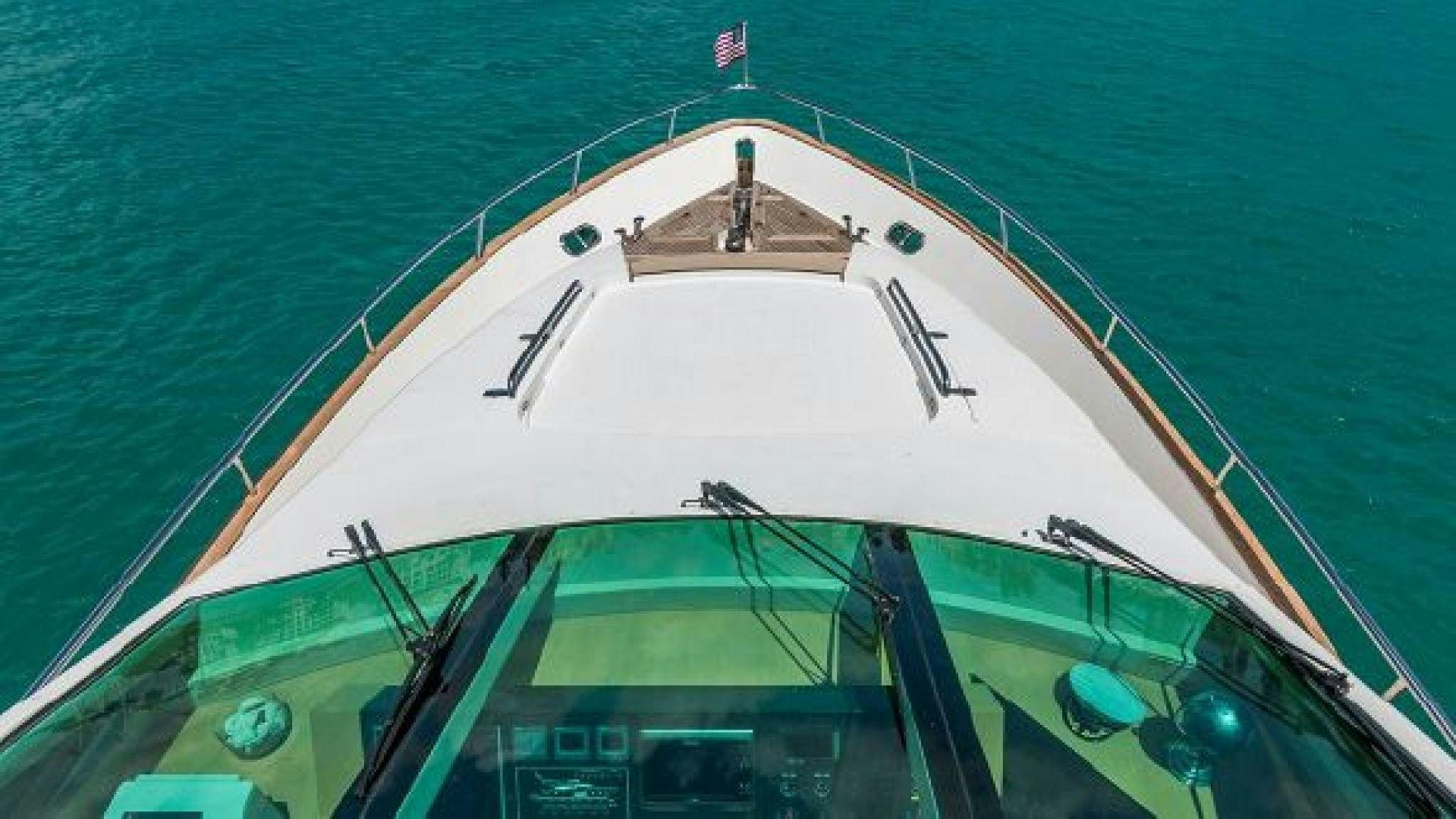 a large white boat with a sail on the water aboard NO LIMITS Yacht for Sale