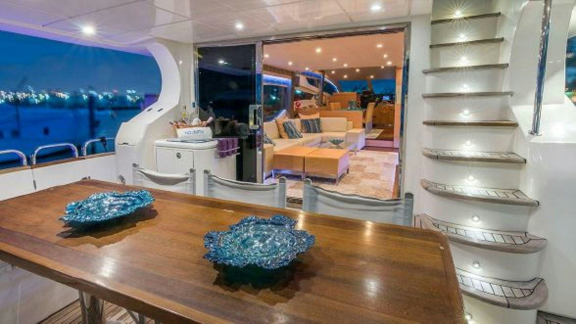a large room with a table and chairs aboard NO LIMITS Yacht for Sale