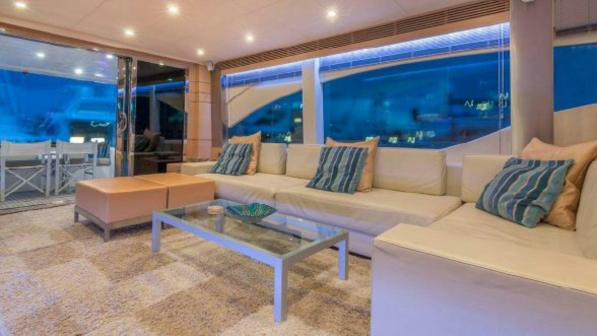 a living room with a couch and a table aboard NO LIMITS Yacht for Sale