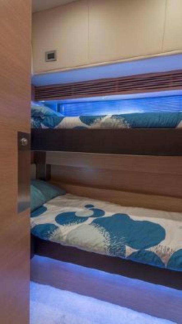 a bed with a blue blanket aboard NO LIMITS Yacht for Sale