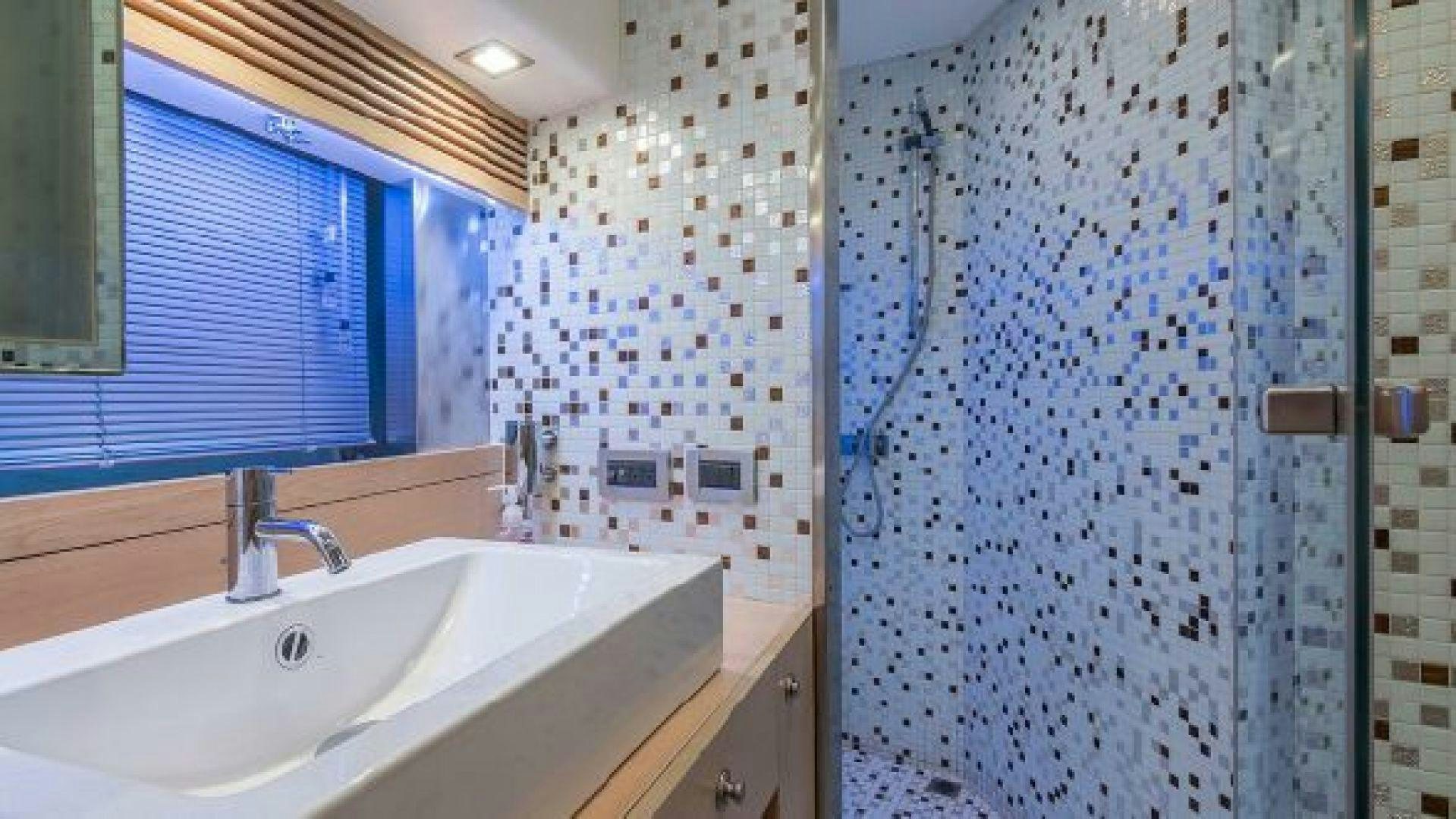 a bathroom with a shower curtain aboard NO LIMITS Yacht for Sale