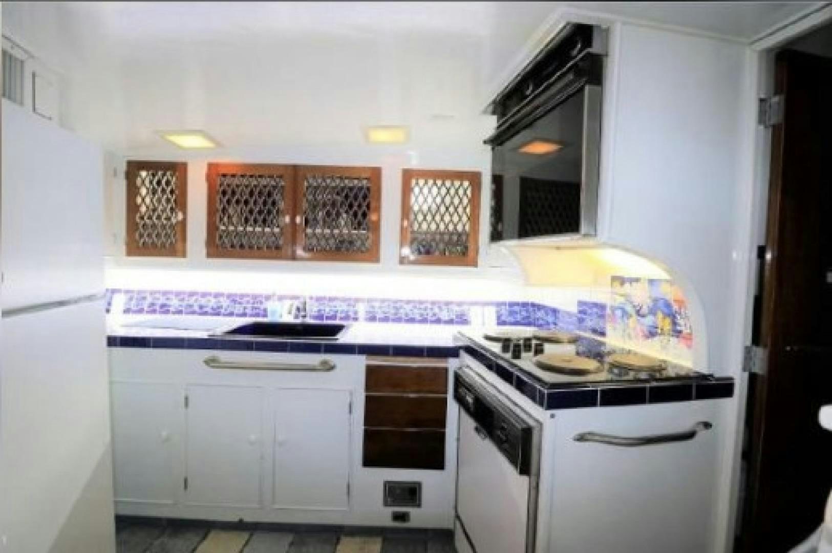 a kitchen with white cabinets aboard FANTASEA Yacht for Sale