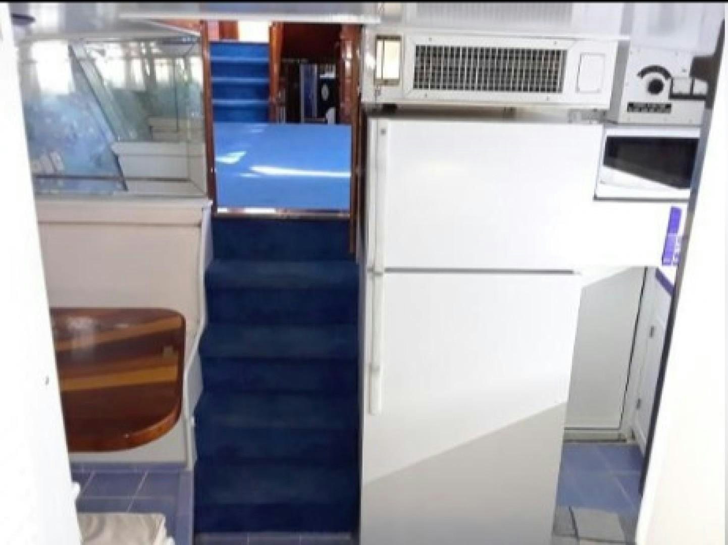 a white refrigerator in a kitchen aboard FANTASEA Yacht for Sale