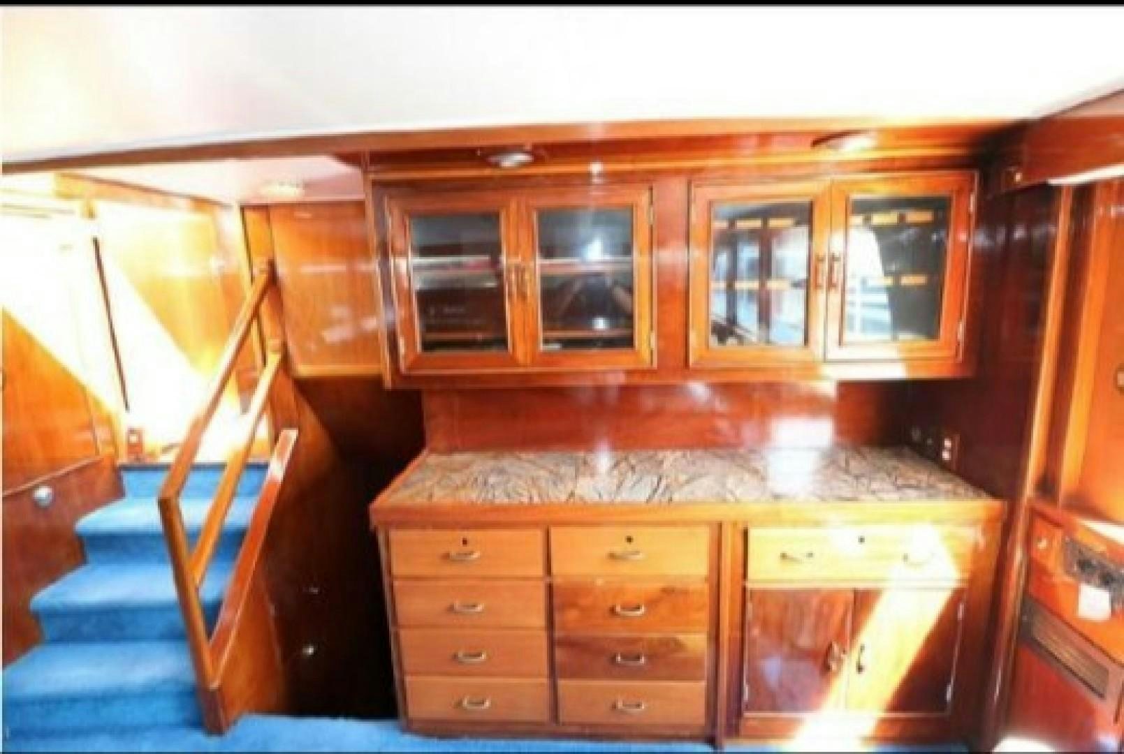 a kitchen with wooden cabinets aboard FANTASEA Yacht for Sale