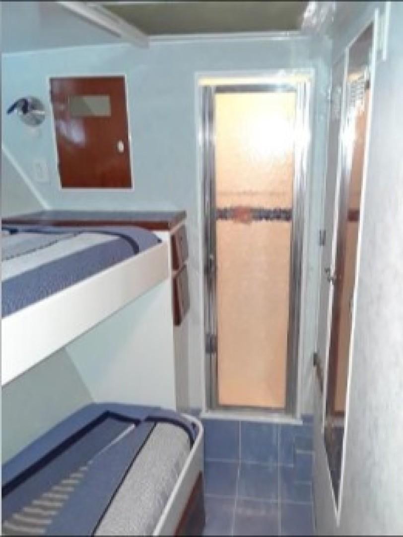 a room with a window and a door aboard FANTASEA Yacht for Sale