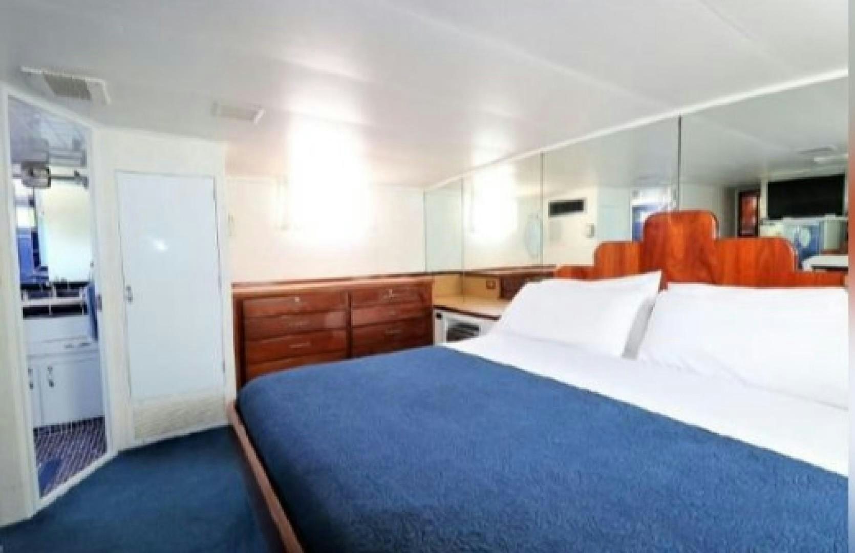 a room with a bed and a desk aboard FANTASEA Yacht for Sale