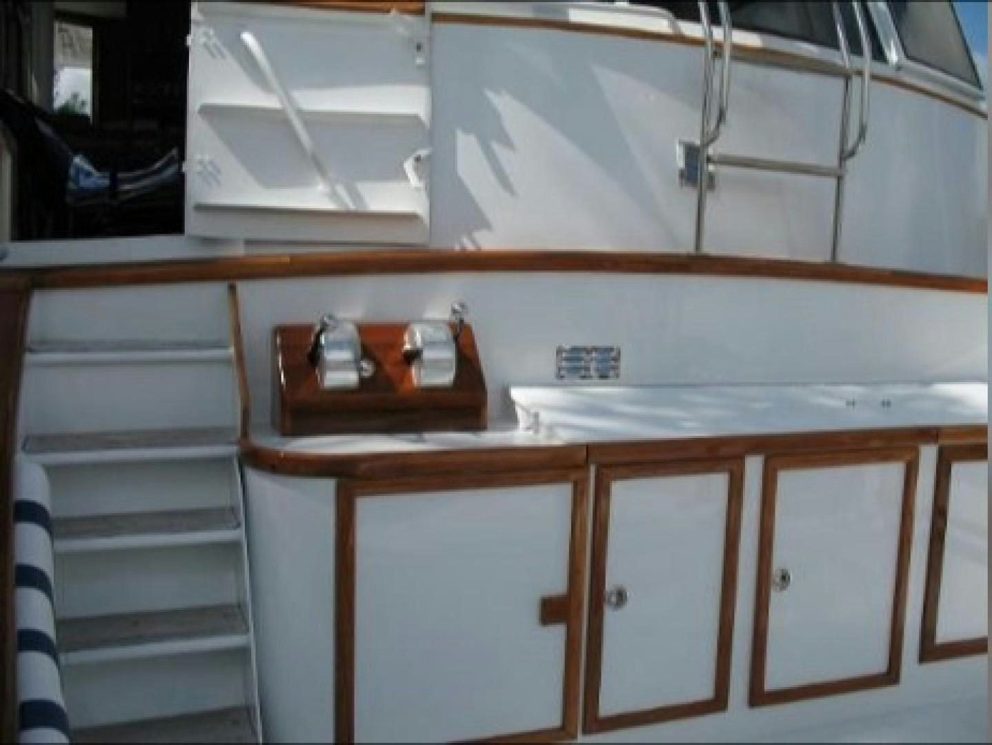 a kitchen with white cabinets aboard FANTASEA Yacht for Sale